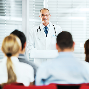 A male doctor communicating with other physicians