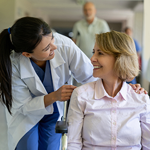A female doctor pushing her patient in a wheelchair